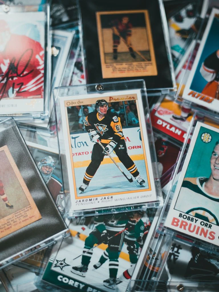 A graded PSA-encased vintage card beside a wholesale order sheet on a dealer counter.