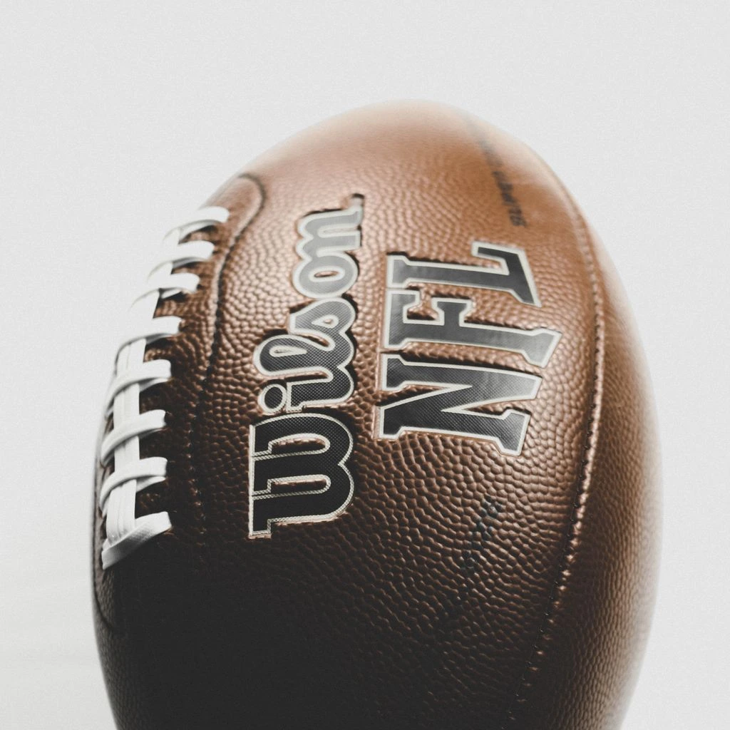 Graded football slabs photographed on a wholesale packing bench.